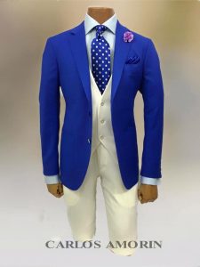 A blue suit and white pants with a polka dot tie.