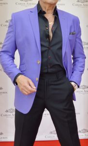 A man in purple jacket and black pants.