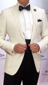 A man in white suit and black pants.