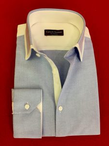 A blue shirt with white collar and cuffs