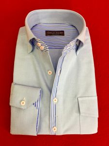 A light blue shirt with two striped shirts on it.