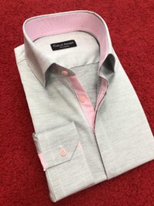 A custom made grey and pink shirt on a red carpet.