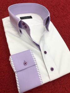 A white shirt with purple buttons and a purple collar.