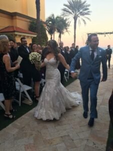 A bride and groom walking down the aisle.