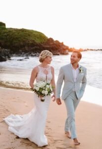 A man and woman walking on the beach