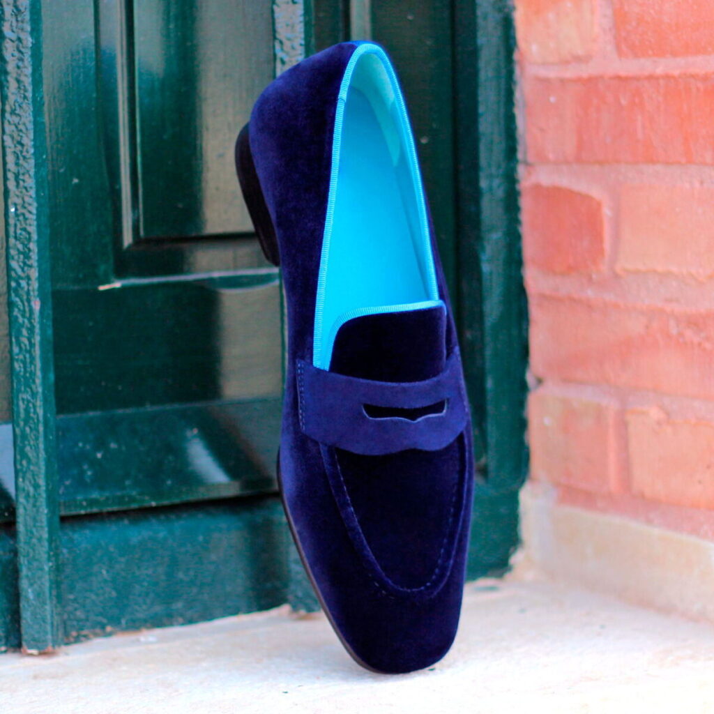 A blue shoe is on the ground outside